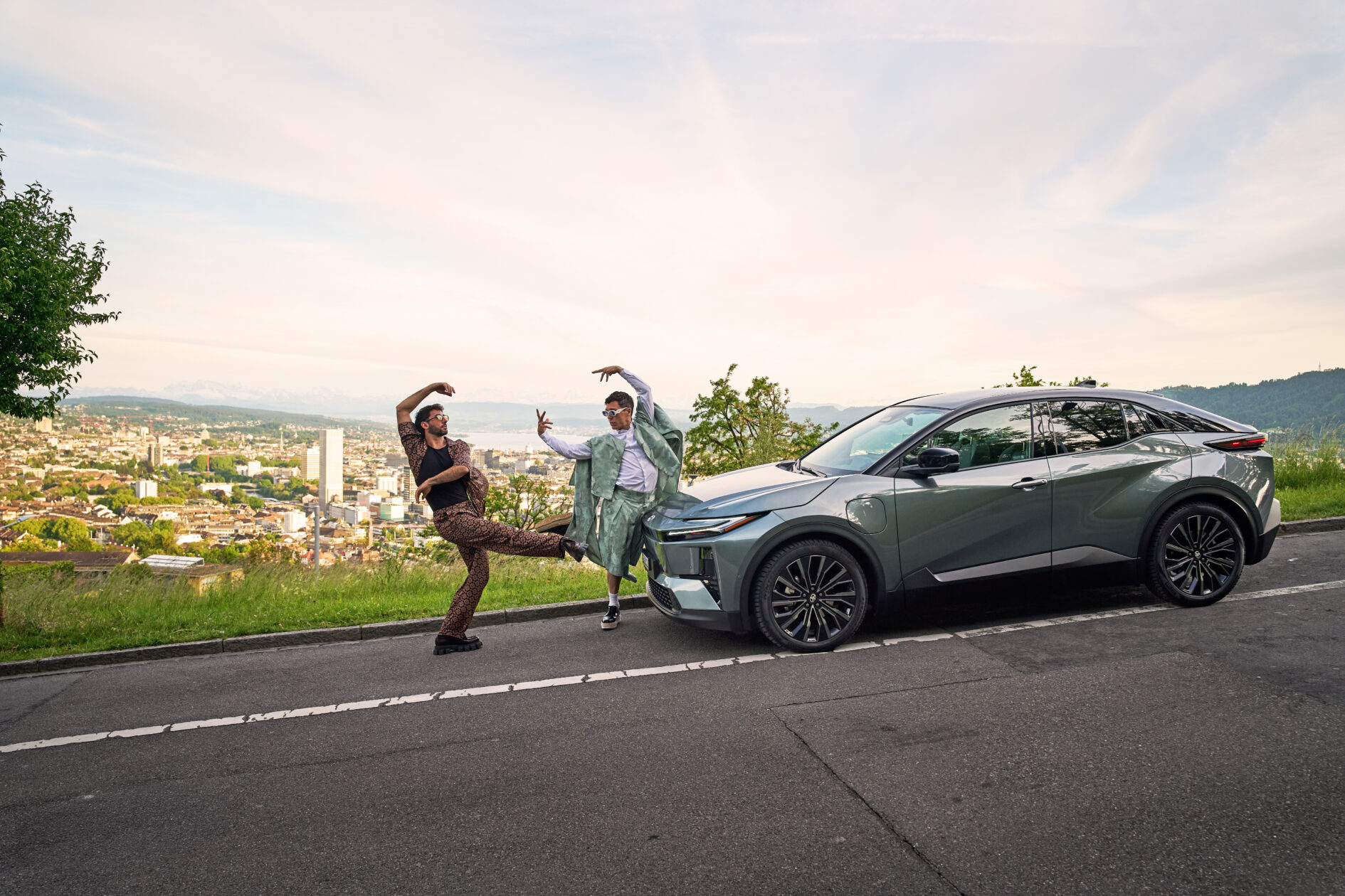 Zwei Männer tanzen auf der Straße vor einem Toyota C-HR.